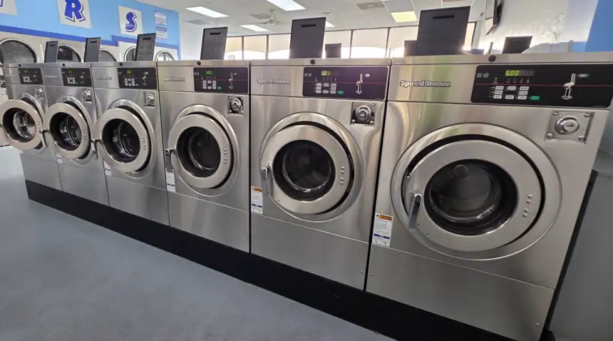 A row of brand-new commercial Speed Queen washers inside The Laundry Room in Palm Bay